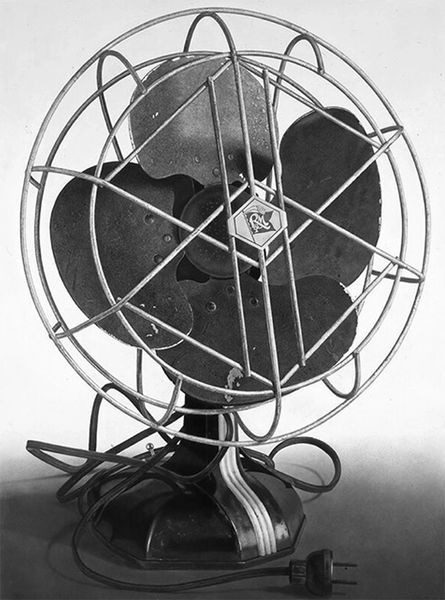 A black and white photo of an old fashioned fan.