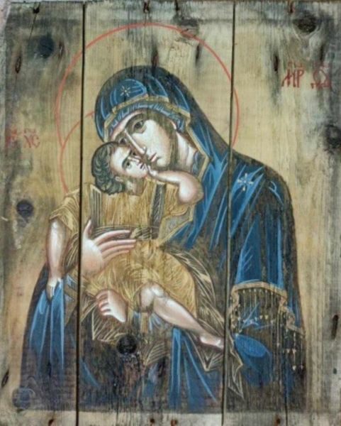 A painting of mary holding jesus in her arms.