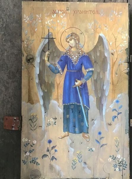 A painting of an angel holding a cross.
