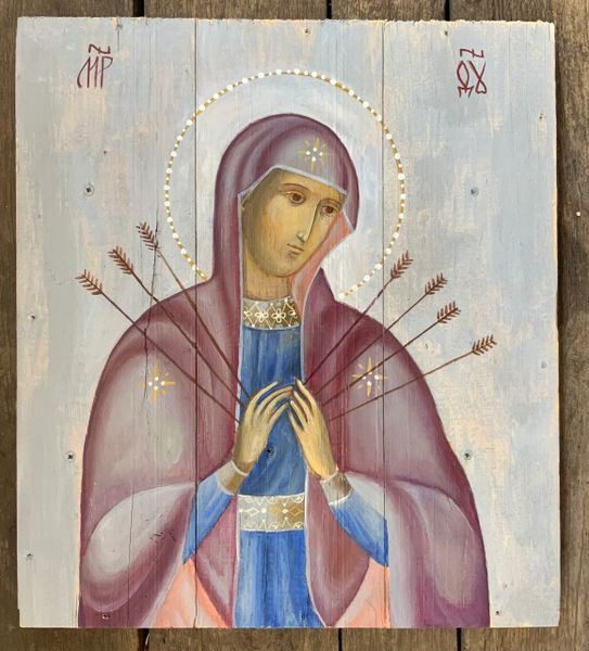 A painting of the virgin mary with arrows in her hands.