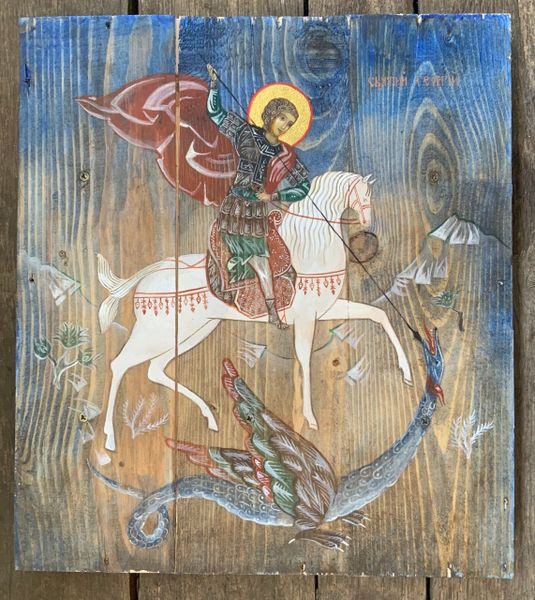 A painting of st. George on horseback with the dragon in the background