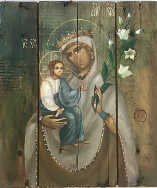 A painting of jesus and mary on the side of a wall.
