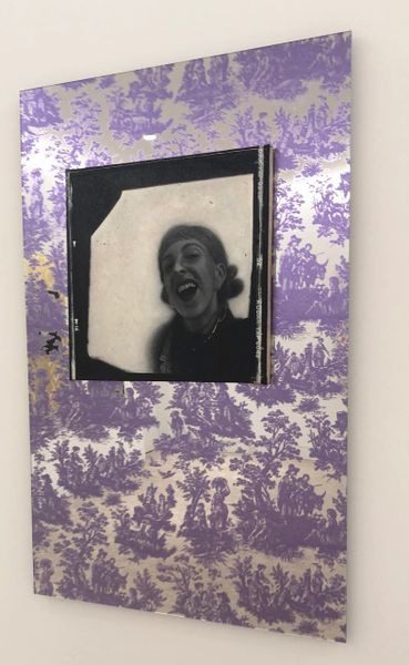 A purple and white picture of a woman in a mirror.