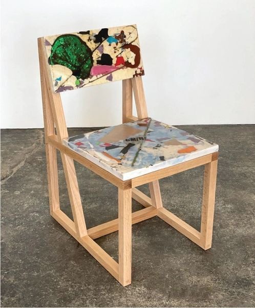 A wooden chair with a picture of people on it.