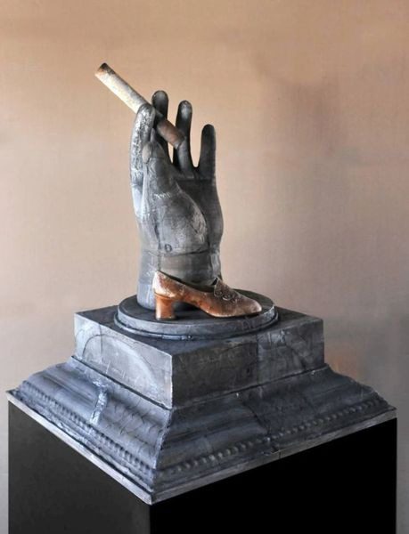A statue of a hand holding a cigarette.