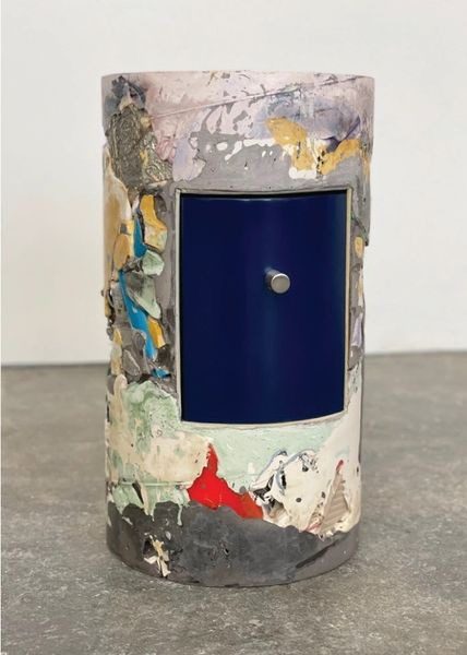 A close up of a vase with some paint on it