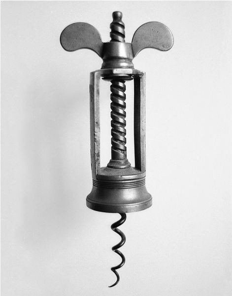 A black and white photo of an old corkscrew.