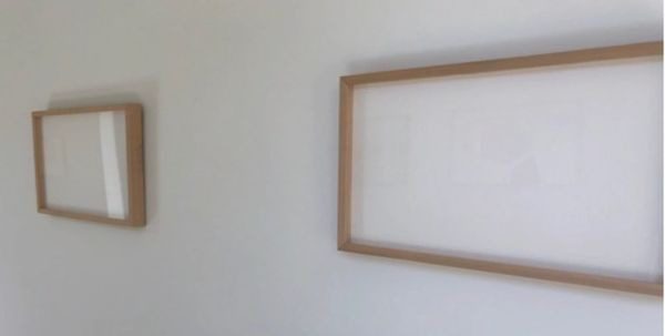A picture frame hanging on the wall in a room.