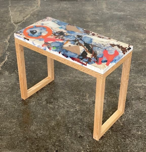 A table with a wooden frame and a colorful top.