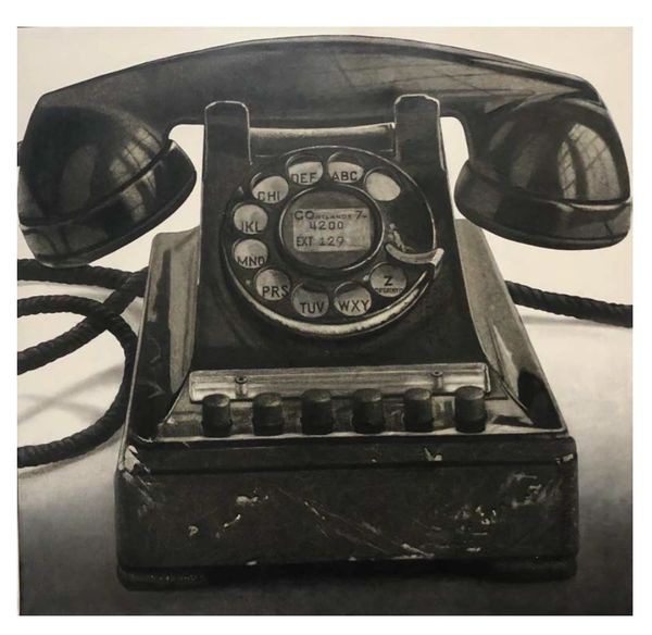 A black and white photo of an old telephone.
