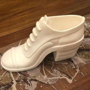 A white shoe is on the ground