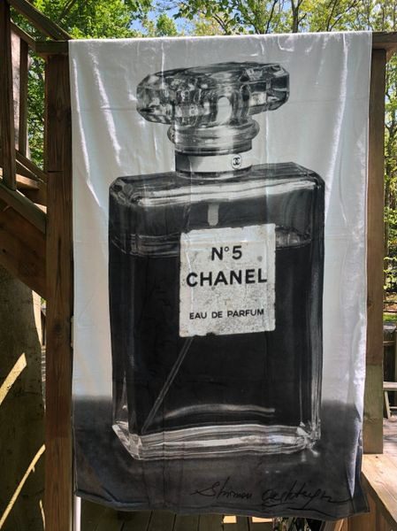 A black and white picture of a bottle of chanel no. 5