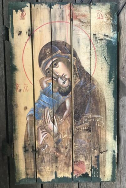 A painting of jesus and mary on the side of a building.