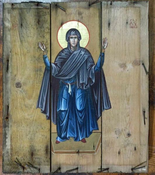A painting of an archangel michael on the side of a wooden door.