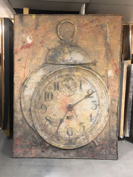 A painting of an old clock on the wall