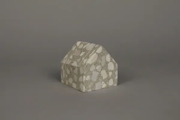 A small house made of paper on top of a table.