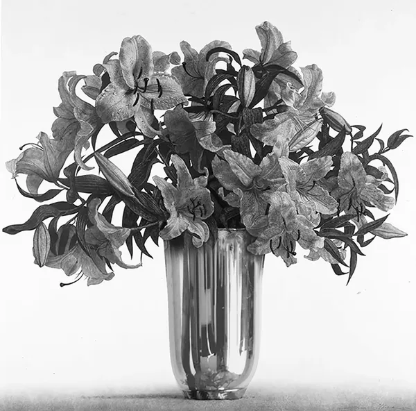 A vase filled with flowers on top of a table.
