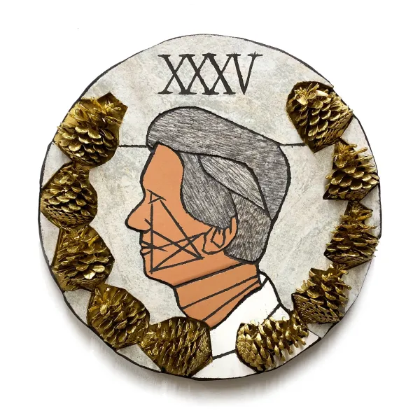 A round plate with a picture of a man 's face and gold trim around it.