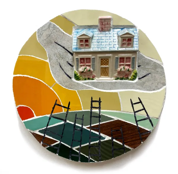 A round plate with a house on it