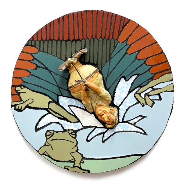 A plate with food on it and the picture is of frog.