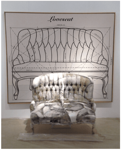 A chair in front of a drawing of a couch.