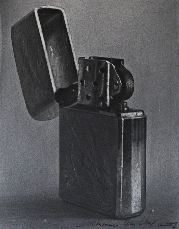 A black and white photo of an old lighter.